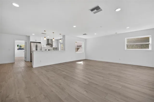 a view of a kitchen with a sink and a large window