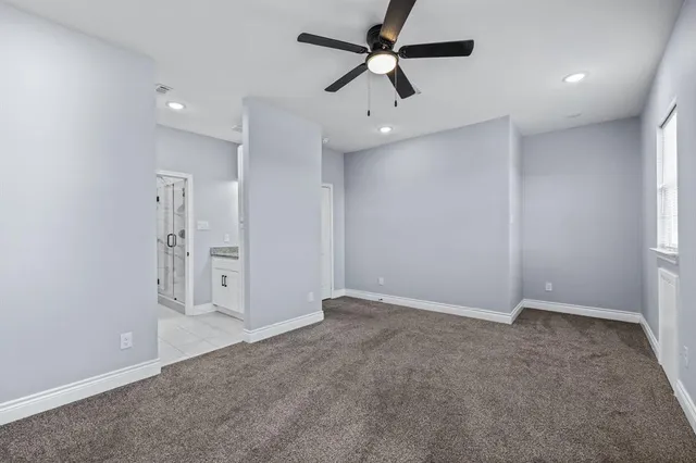 wooden floor in an empty room with a ceiling fan