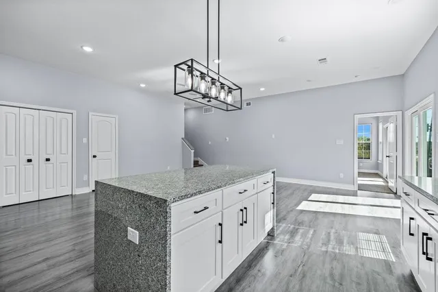 a kitchen that has a lot of cabinets in it