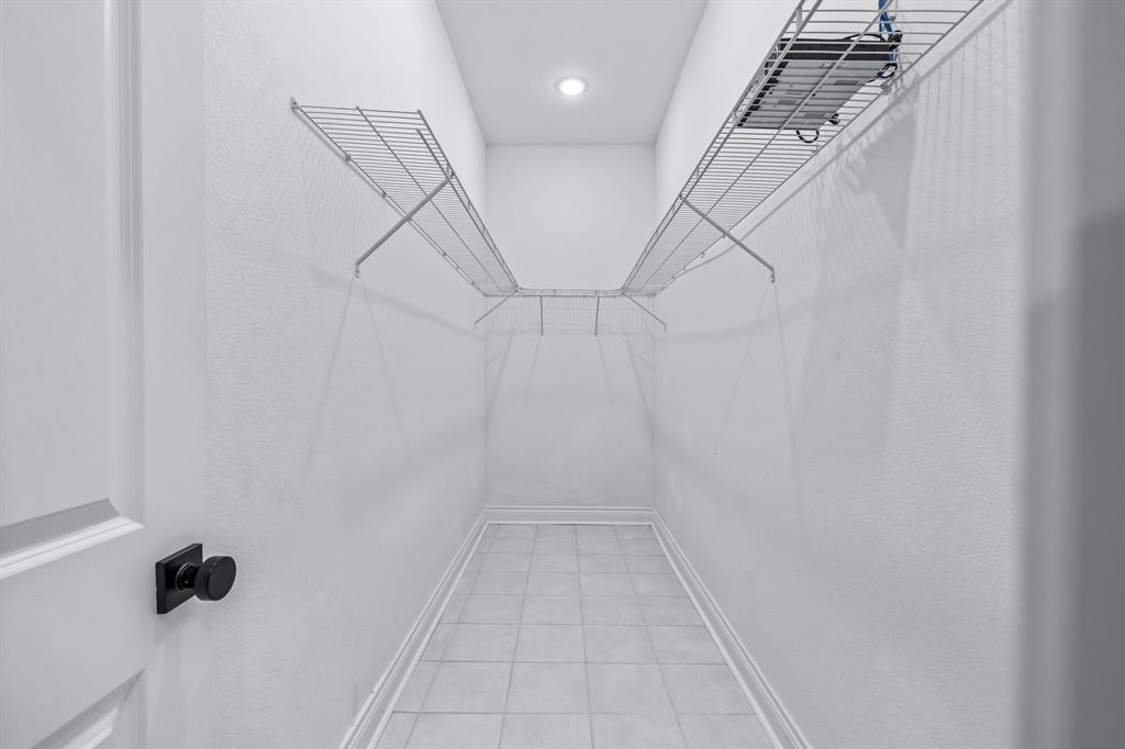 1701 Belzise Terrace Fort Worth, TX 76104 - Photo 3 of 35 a view of a room with racks on the wall