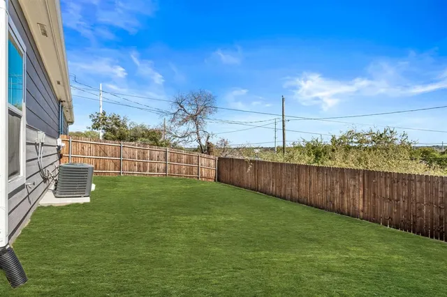 a view of a yard with a fence