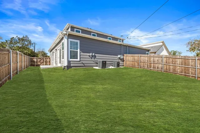 a view of a house with a yard and sitting area