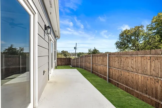 a view of a backyard with wooden fence
