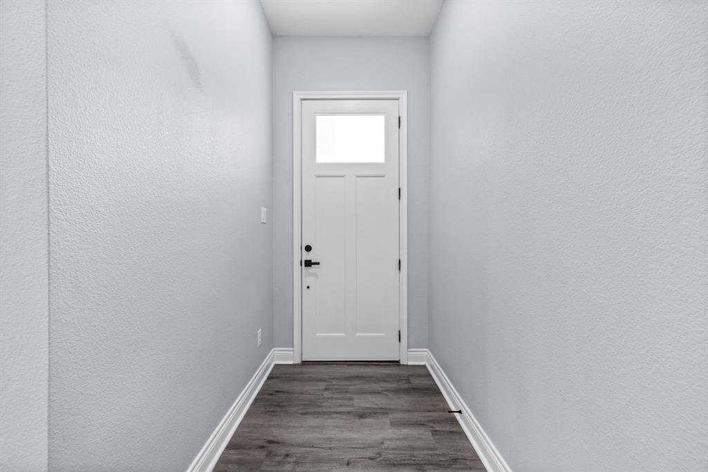 1701 Belzise Terrace Fort Worth, TX 76104 - Photo 7 of 35 a view of a hallway with wooden floor