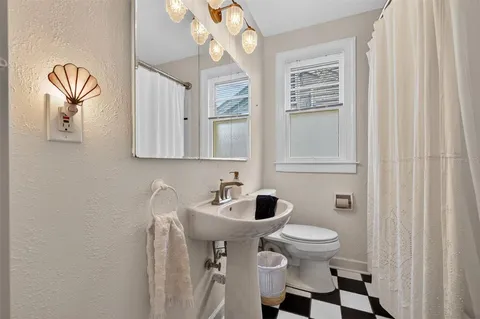 a white toilet sitting next to a bathroom sink