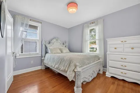 a spacious bedroom with a bed and a window