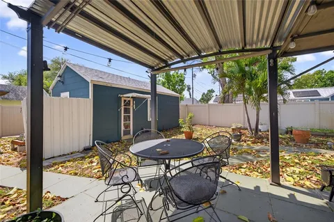 a view of house with backyard and outdoor seating