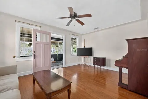 a living room with furniture a window and a flat screen tv