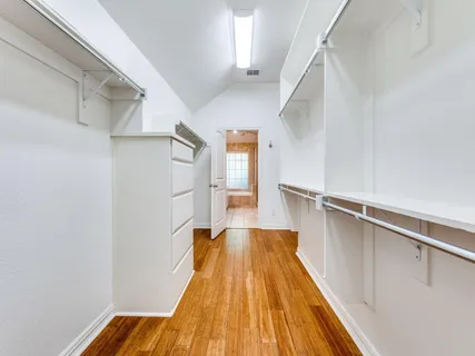 a bedroom with a bed and a potted plant