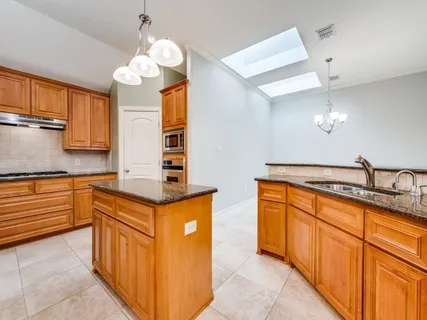 a kitchen with stainless steel appliances granite countertop a stove sink and microwave