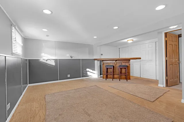 a large room with stainless steel appliances kitchen island sink and refrigerator