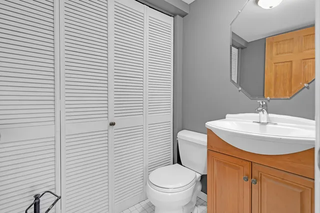 a bathroom with a toilet a sink and mirror