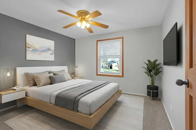 a bedroom with a bed and a potted plant