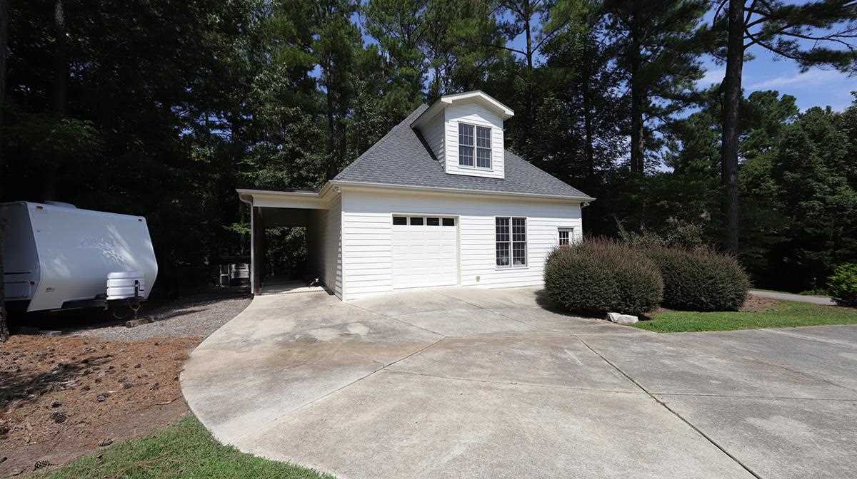 Workshop-Garage with Single Car Garage Door. Previously used as a Wood Working Center. Great Bonus Room Upstairs and all Heated and Cooled !!! Detached Garage