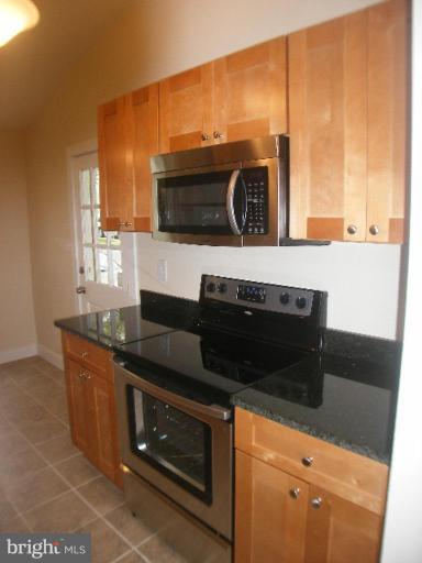 3761 Stonesboro Road Fort Washington, MD 20744 - Photo 2 of 30 a kitchen with stainless steel appliances granite countertop a stove a sink and a microwave