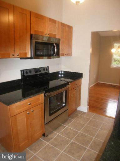 3761 Stonesboro Road Fort Washington, MD 20744 - Photo 3 of 30 a kitchen with granite countertop a stove and a microwave