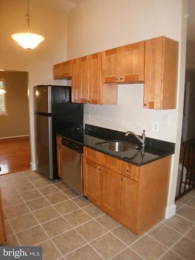 3761 Stonesboro Road Fort Washington, MD 20744 - Photo 5 of 30 a kitchen with granite countertop a refrigerator and a sink