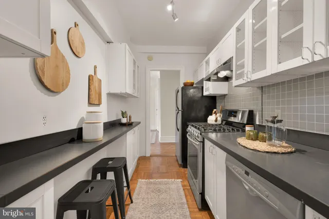 a kitchen with a sink appliances and cabinets