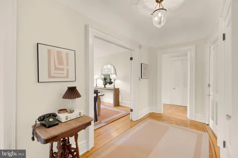 a bedroom with furniture and a mirror