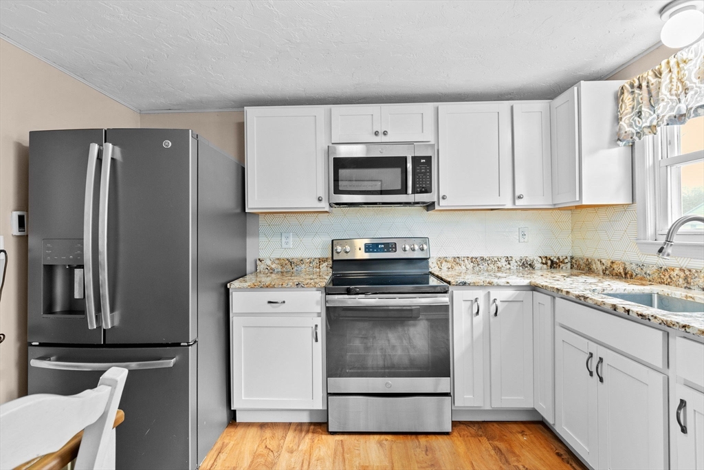 5 Len Road Holbrook, MA 02343 - Photo 3 of 30 a kitchen with cabinets stainless steel appliances and a counter space