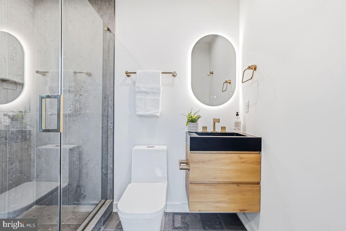 3554 T Street Northwest Washington, DC 20007 - Photo 42 of 57 a bathroom with a toilet a sink and mirror