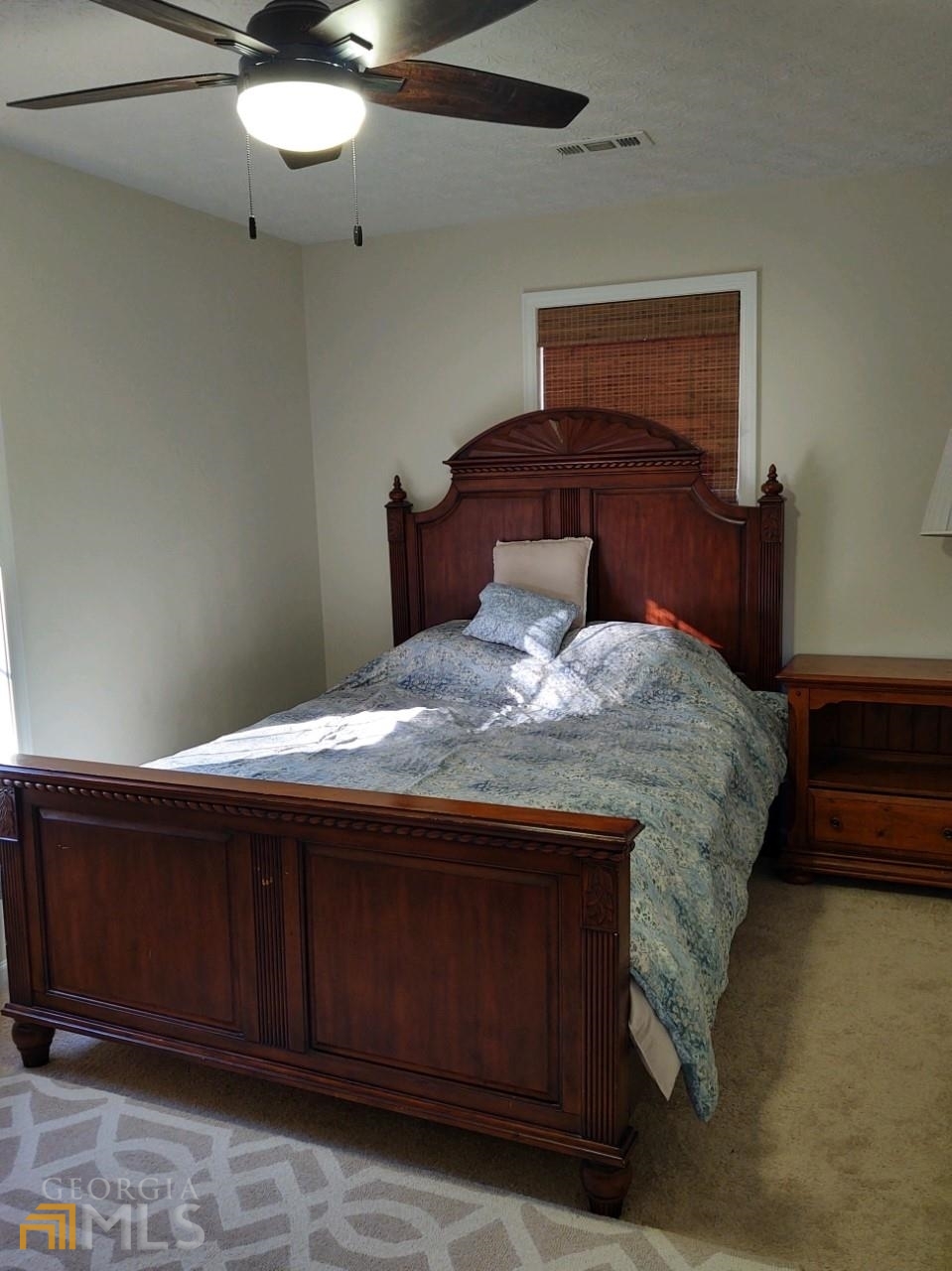 1467 Elders Mill Road, Unit ABOVE Senoia, GA 30276 - Photo 14 of 18 a bedroom with a bed and a table
