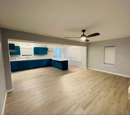 a view of a kitchen with a sink and a fireplace