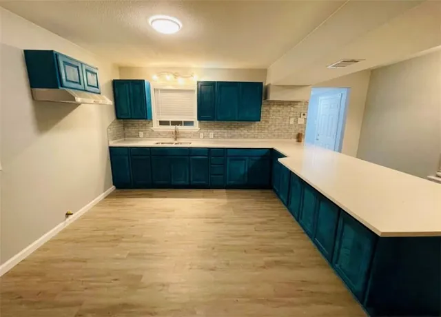 a view of a room with wooden floor