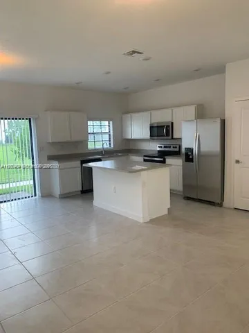 a kitchen with stainless steel appliances a refrigerator sink and stove