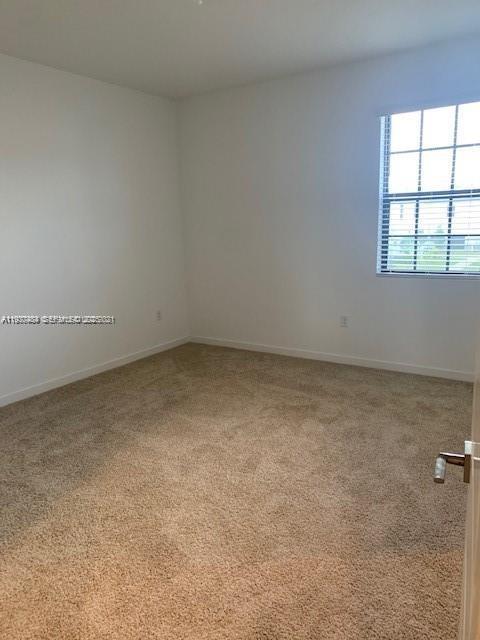 731 Southwest 11th Street Florida City, FL 33034 - Photo 9 of 13 an empty room with a window