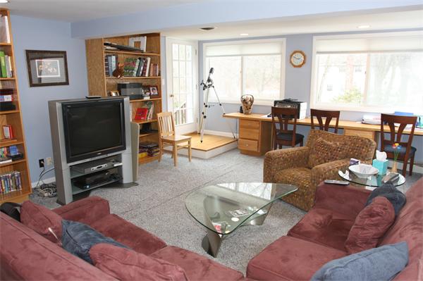64 Damon Road Needham, MA 02494 - Photo 6 of 19 a living room with furniture a large window and a flat screen tv