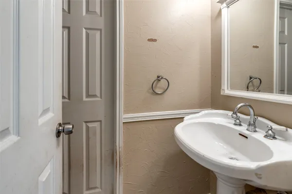 a bathroom with a sink and mirror