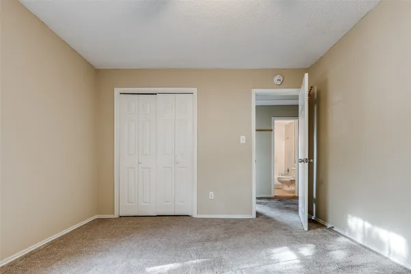an empty room with closet in front of door