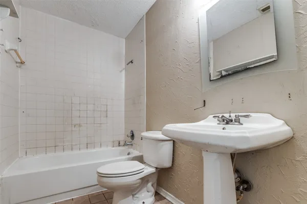 a bathroom with a sink toilet mirror and shower