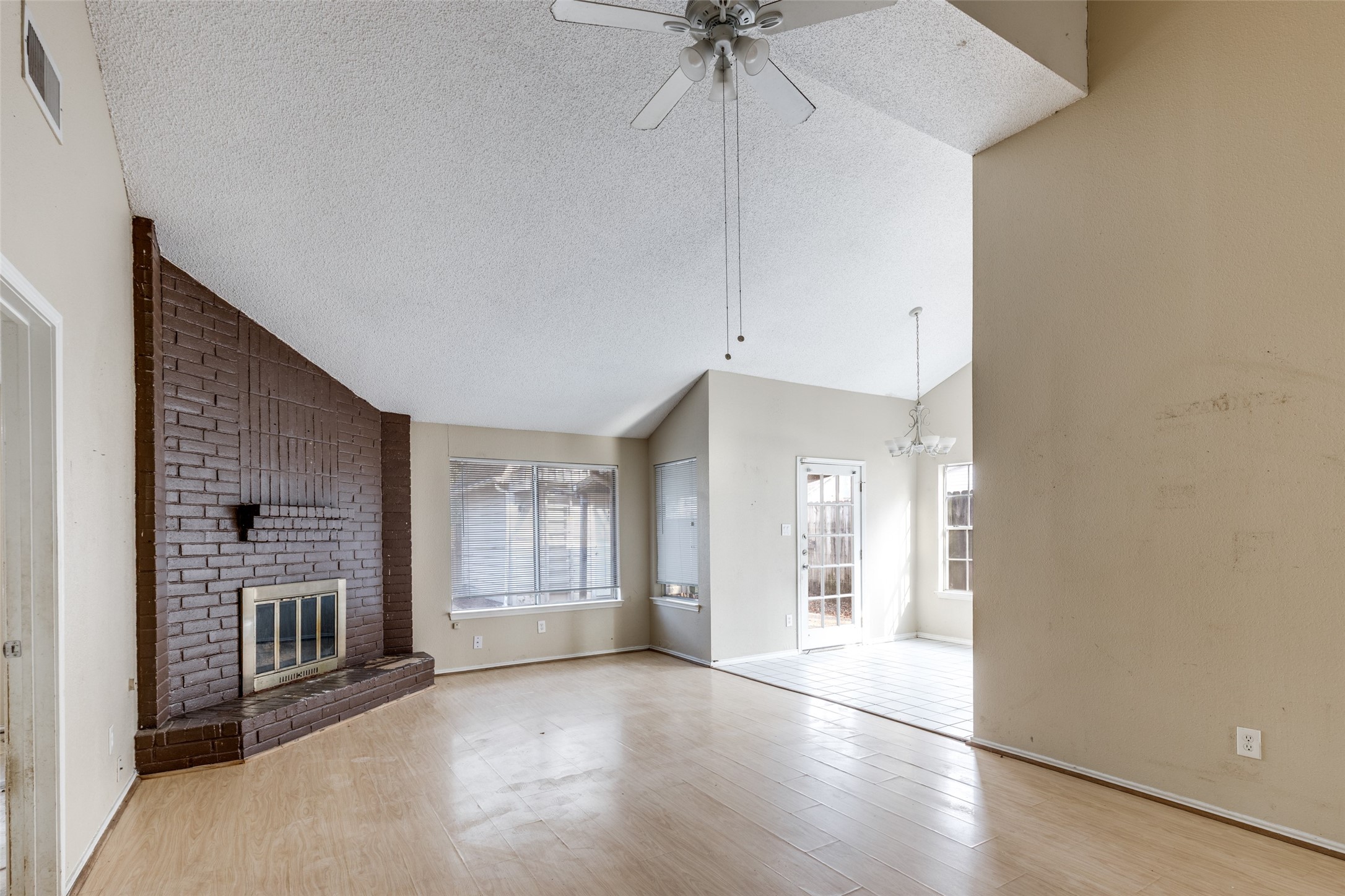 24010 Landing Way Drive Spring, TX 77373 - Photo 3 of 25 a view of an empty room with a kitchen and a window