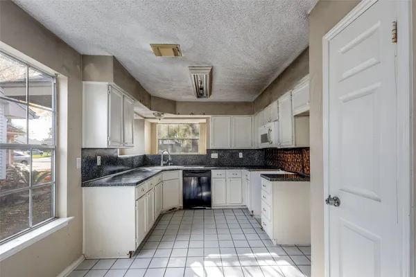a kitchen with stainless steel appliances granite countertop a sink and cabinets