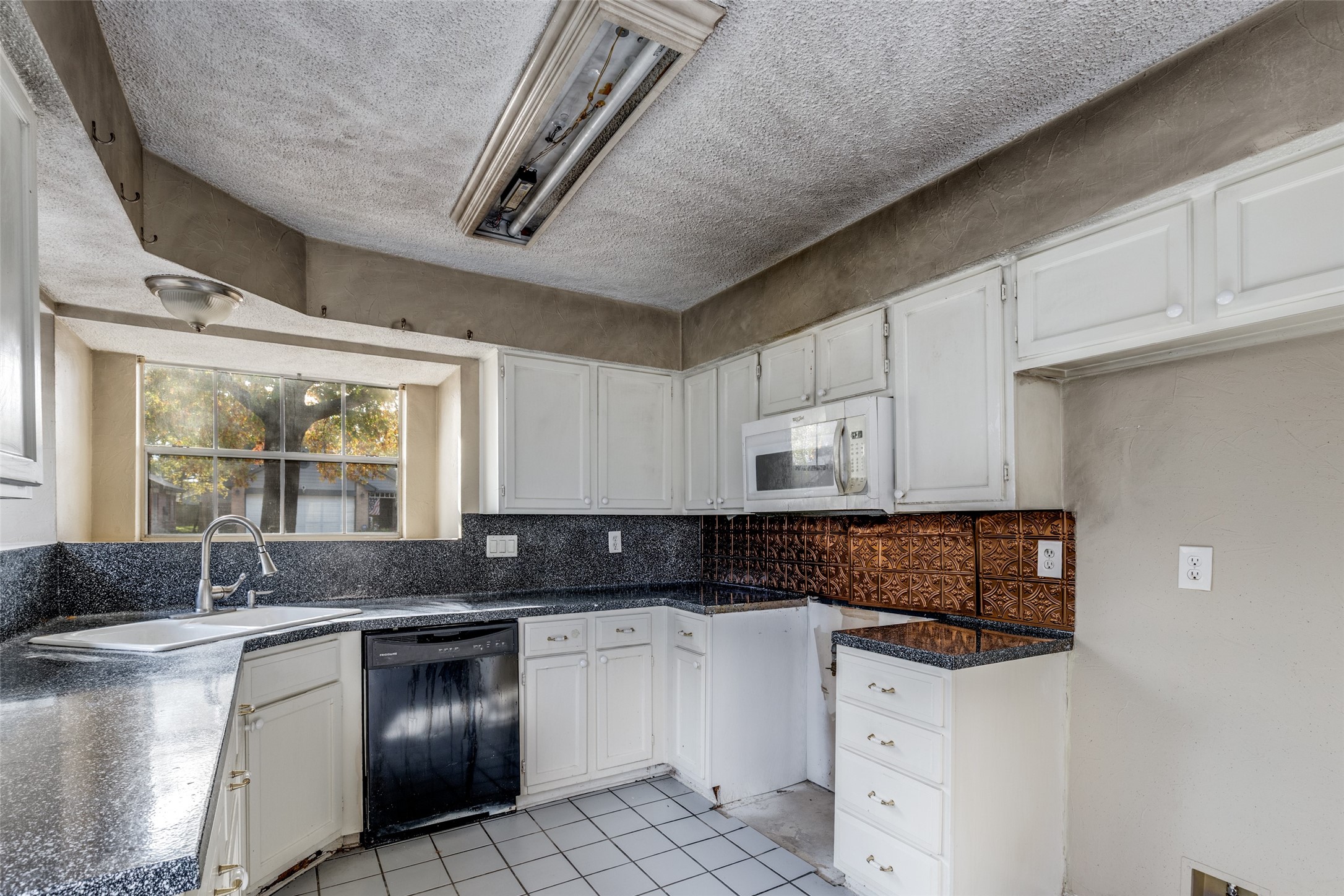 24010 Landing Way Drive Spring, TX 77373 - Photo 8 of 25 a kitchen with granite countertop a sink stove and cabinets