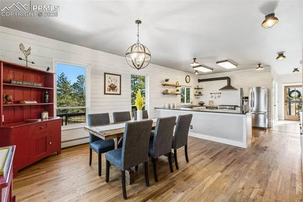 a view of a dining room with furniture window and wooden floor