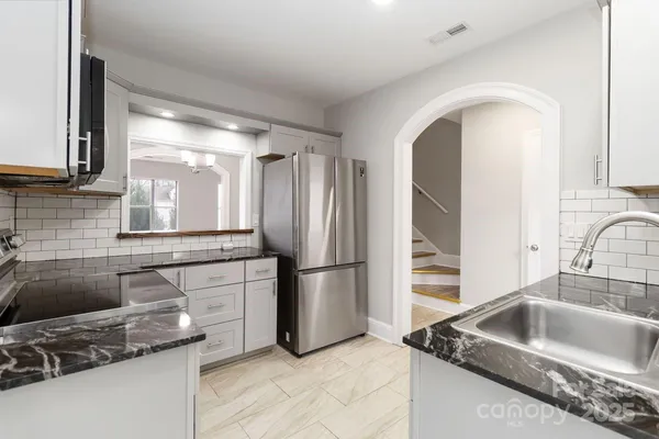 a kitchen with a sink cabinets and stainless steel appliances