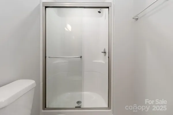 a bathroom with a glass shower door