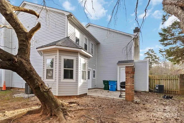 a view of a house with a house and wooden fence