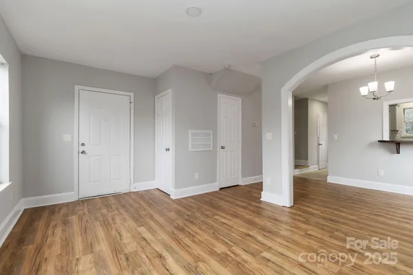a view of an empty room and wooden floor