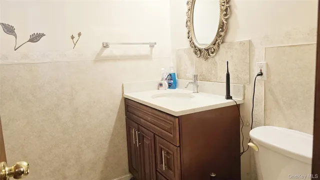 a spacious bedroom with a bed and a dresser next to a window