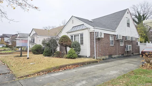 a view of a house with a small yard and plants