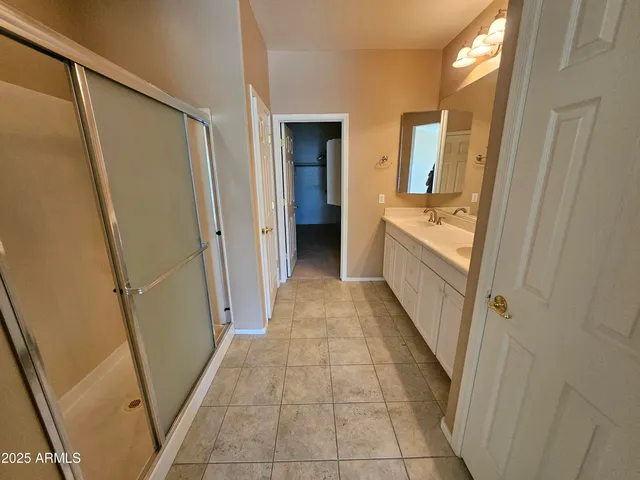 a view of hallway with shower and closet