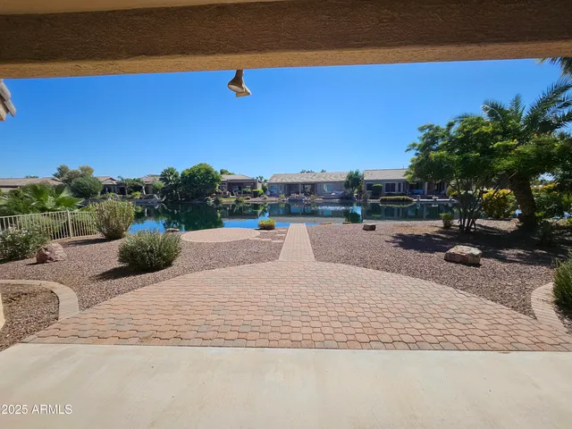 a backyard of a house with table and chairs