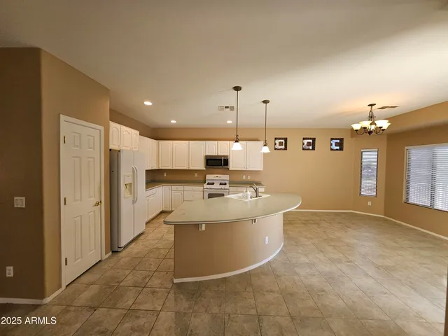 a view of a kitchen with a sink stainless steel appliances cabinets and a counter top space