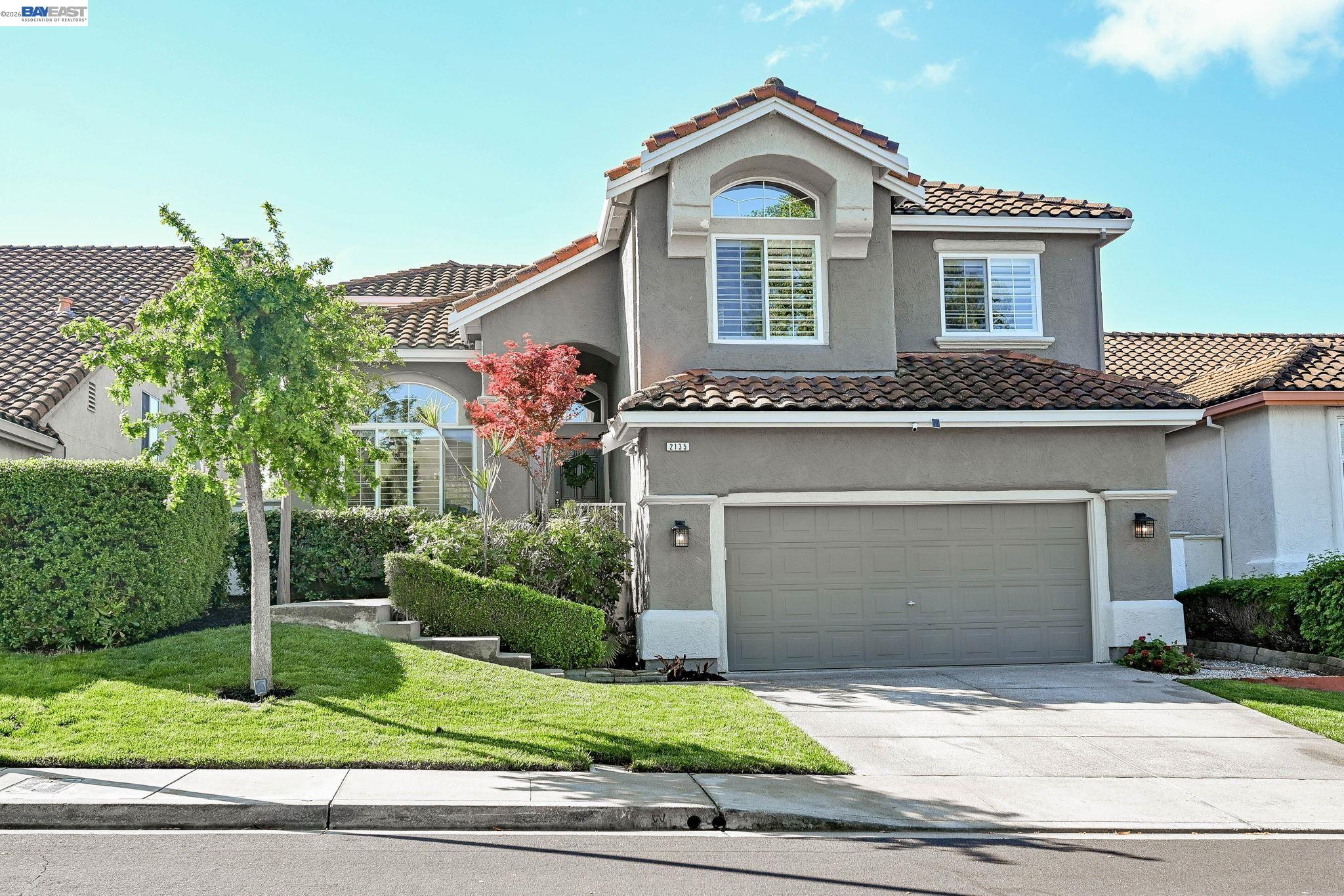 a front view of a house with a yard and garage