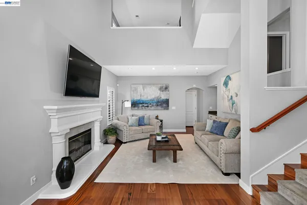 a living room with furniture a fireplace and a flat screen tv