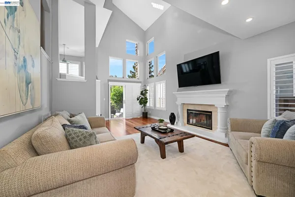 a living room with furniture a fireplace and a flat screen tv